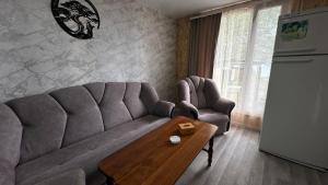a living room with a couch and a table at Voyage in Sevan