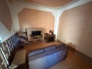 a living room with a couch and a fireplace at House by the Sea in Herceg-Novi