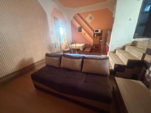 a living room with a couch and some stairs at House by the Sea in Herceg-Novi