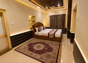 a hotel room with a bed and a rug at Hotel Robin Jaisalmer Near fort view in Jaisalmer