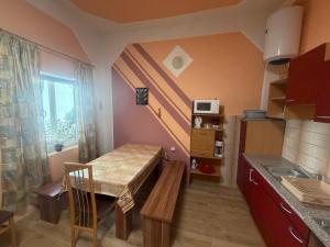 a small kitchen with a table and a sink and a table and a table at House by the Sea in Herceg-Novi