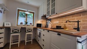 a kitchen with a sink and a counter top at Calma Apartments Gattendorf in Gattendorf