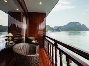 a balcony on a cruise ship looking out over the water at Aqua of the Seas Cruise in Ha Long +55 photos