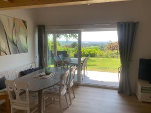 a dining room with a table and chairs and a sliding glass door at Fewo Fernblick in Much