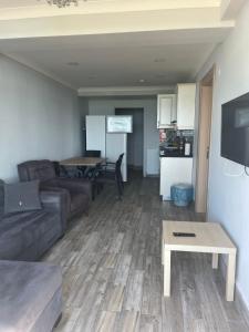 a living room with a couch and a table at Seyran Seaside Apartments- 2-garden floor in Trabzon