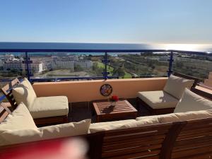 a balcony with couches and a table and a view at Panoramic Atalaya in Mojácar