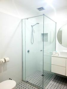 a glass shower in a bathroom with a toilet at Bay & Basin in Sanctuary Point +26 photos