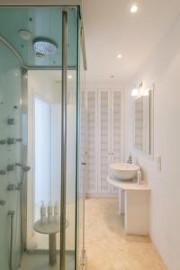 a bathroom with a glass shower and a sink at Sunset Flower Villa in Kástron +74 photos