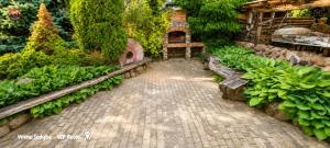 a garden filled with lots of green plants at Vilimu Sodyba - VIP Room in Kriukai +3 photos
