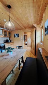 a dining room and kitchen with a large wooden table at Ferienhaus Berger in Virgen