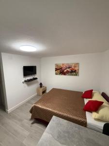 a bedroom with a bed and a flat screen tv at Apartments Šestan in Novalja