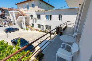 a balcony with a table and chairs and a building at Hotel Aleks in Shkodër