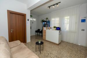 a living room with a couch and a refrigerator at Hotel Aleks in Shkodër +65 photos
