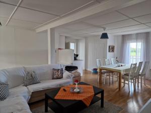 a living room with a white couch and a table at Manus Ferienwohnung in Brevik