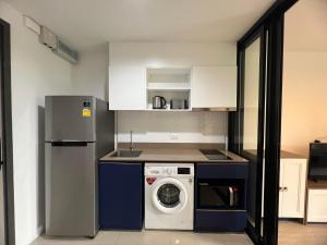 a kitchen with a washing machine and a refrigerator at The Base Central Phuket-B2-Y9B in Ban Rangeng