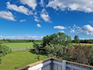 a view of a field from the balcony of a house at Manus Ferienwohnung in Brevik
