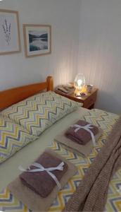 a bedroom with two beds with towels on them at Apartmani Lazaro in Višegrad