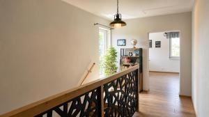 a hallway with a stairway with a stair railing at Śpij w Kudowie Apartament i pokoje gościnne in Kudowa-Zdrój