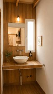 a bathroom with a white sink and a window at Raíces in Puerto Pirámides +27 photos