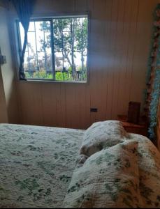 a bedroom with a bed and a window at Loft vista a la bahía in Valparaíso