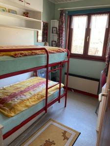 a room with two bunk beds and a rug at Maison Catharina in Vielsalm