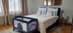 a bedroom with a black and white bed with white pillows at aNNa s Cozy Home with Private Forest, Canopy Terrace & Parking, near Red Bull Ring in Sankt Michael in Obersteiermark