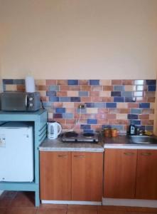 a kitchen with a stove and a sink in it at Loft vista a la bahía in Valparaíso