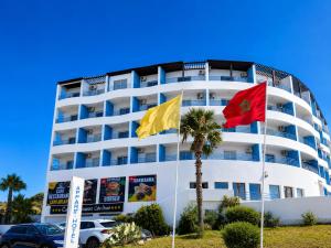 two flags in front of a hotel at Appart Hôtel Cabo Dream in Cabo Negro