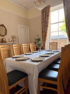 a dining room table with chairs and a large window at Kirkland in Berwick-Upon-Tweed +28 photos