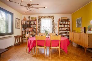 a dining room with a red table and chairs at Maison Serra - Jacuzzi, Sauna in Collioure