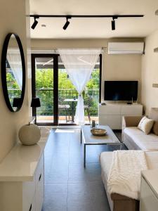 a living room with a couch and a table at Luxury Central Apartment in Plovdiv