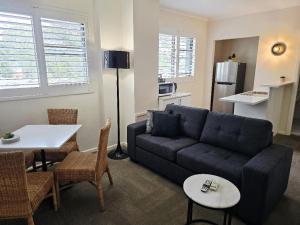 a living room with a couch and a table at Bay & Basin in Sanctuary Point