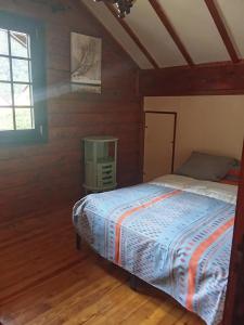 a bedroom with a bed in a wooden room at Chalet Borce 64 in Borce