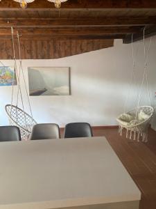 a conference room with a white table and chairs at Vacanza nella Natura in Punta Ala +5 photos