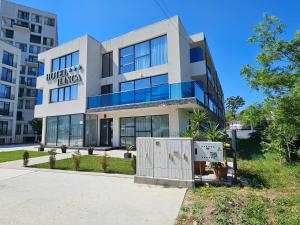 a building with a sign on the front of it at Ilinca in Neptun
