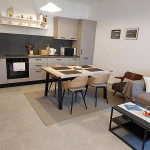 a kitchen and living room with a table and chairs at Apartment Mare - Beachfront in Rabac