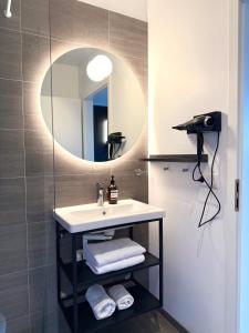 a bathroom with a sink and a mirror at Seljavellir Guesthouse in Höfn