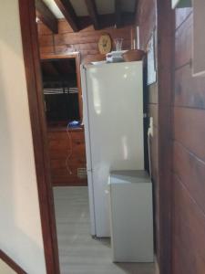 a white refrigerator in a room with a door at Chalet Borce 64 in Borce