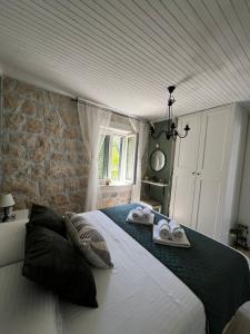 a bedroom with a large bed with towels on it at Charming apartment piccolo paradiso in Vlašići +37 photos