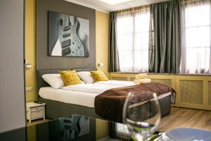 a bedroom with a bed with a guitar on the wall at VillaJazz Apartments in Murau