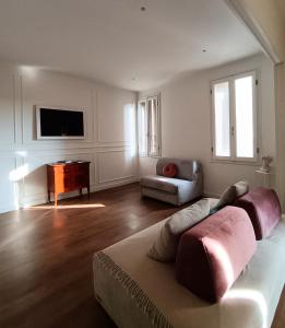 a living room with a couch and a tv at Lodge 46 Luxury Apartment in Marghera