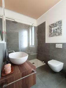 a bathroom with a white sink and a toilet at Lodge 46 Luxury Apartment in Marghera +36 photos