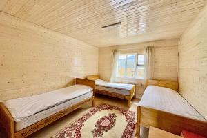 a small room with two beds and a window at BTMongolia Guest house Tour Operator in Ölgiy
