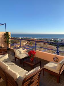 a balcony with chairs and a view of the ocean at Panoramic Atalaya in Mojácar