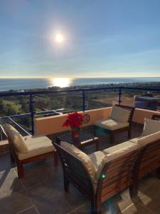 a balcony with benches and a view of the ocean at Panoramic Atalaya in Mojácar +50 photos