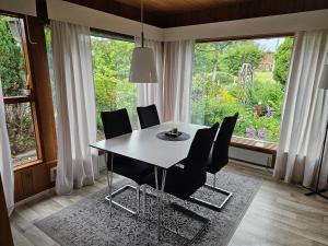 a dining room with a table and chairs and a window at Sandmo Holiday Home 11 in Eckerö