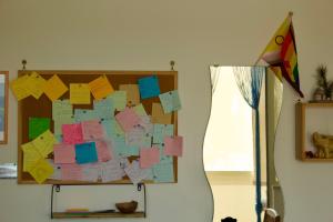 a bulletin board with sticky notes on a wall at Casa Arcobaleno in Marsala