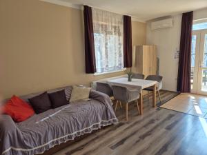 a living room with a couch and a table at Diófa Vendégház in Eger