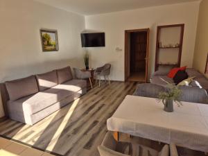 a living room with a couch and a table at Diófa Vendégház in Eger
