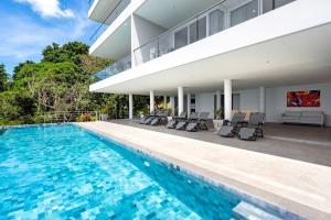 a villa with a swimming pool and a house at The Residence Seaview in Nathon Bay